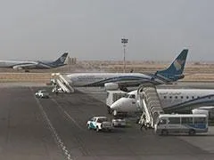Two airplanes on a airport in Oman