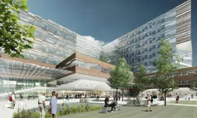 Illustration af et stort og moderne universitetshospital med glasfacade og mennesker på pladsen foran.